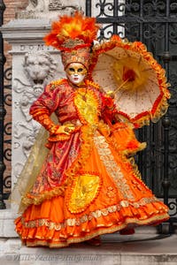 People in costume at the Venice Carnival in front of the Venetian Arsenal.