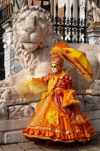 People in costume at the Venice Carnival in front of the Venetian Arsenal.