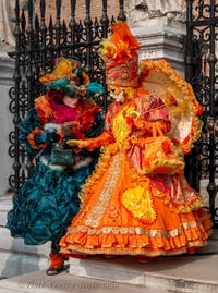 People in costume at the Venice Carnival in front of the Venetian Arsenal.