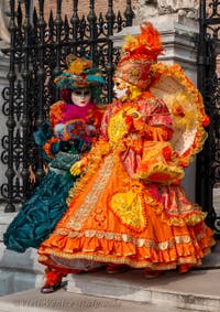 People in costume at the Venice Carnival in front of the Venetian Arsenal.