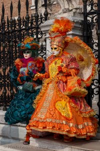 People in costume at the Venice Carnival in front of the Venetian Arsenal.