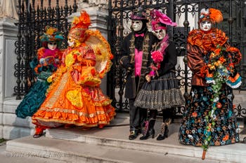 People in costume at the Venice Carnival in front of the Venetian Arsenal.