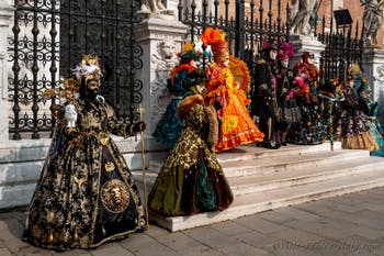 People in costume at the Venice Carnival in front of the Venetian Arsenal.