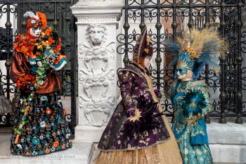 People in costume at the Venice Carnival in front of the Venetian Arsenal.