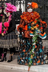 People in costume at the Venice Carnival in front of the Venetian Arsenal.