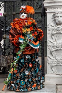 People in costume at the Venice Carnival in front of the Venetian Arsenal.