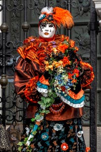 People in costume at the Venice Carnival in front of the Venetian Arsenal.