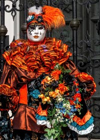 People in costume at the Venice Carnival in front of the Venetian Arsenal.