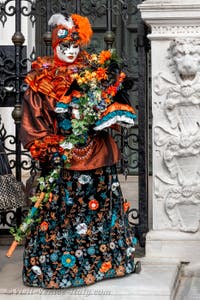 People in costume at the Venice Carnival in front of the Venetian Arsenal.