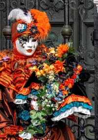 People in costume at the Venice Carnival in front of the Venetian Arsenal.