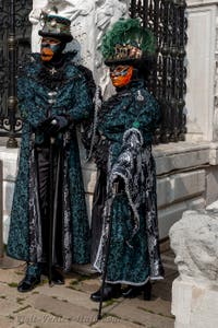 People in costume at the Venice Carnival in front of the Venetian Arsenal.