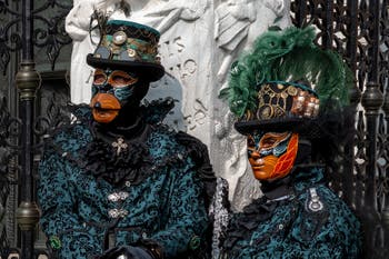 People in costume at the Venice Carnival in front of the Venetian Arsenal.