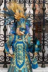 People in costume at the Venice Carnival in front of the Venetian Arsenal.