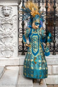 People in costume at the Venice Carnival in front of the Venetian Arsenal.