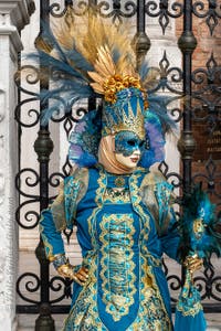 People in costume at the Venice Carnival in front of the Venetian Arsenal.