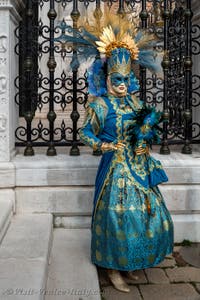 People in costume at the Venice Carnival in front of the Venetian Arsenal.