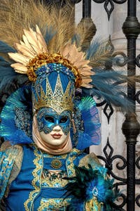 People in costume at the Venice Carnival in front of the Venetian Arsenal.