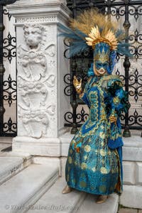 People in costume at the Venice Carnival in front of the Venetian Arsenal.