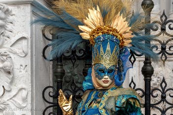 People in costume at the Venice Carnival in front of the Venetian Arsenal.