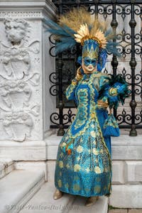 People in costume at the Venice Carnival in front of the Venetian Arsenal.