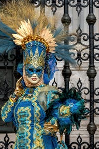 People in costume at the Venice Carnival in front of the Venetian Arsenal.