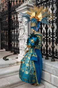 People in costume at the Venice Carnival in front of the Venetian Arsenal.