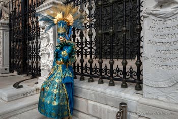 People in costume at the Venice Carnival in front of the Venetian Arsenal.