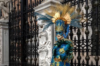 People in costume at the Venice Carnival in front of the Venetian Arsenal.