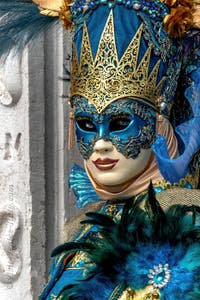 People in costume at the Venice Carnival in front of the Venetian Arsenal.