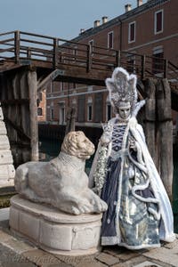 People in costume at the Venice Carnival in front of the Venetian Arsenal.