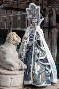 People in costume at the Venice Carnival in front of the Venetian Arsenal.