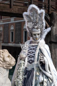 People in costume at the Venice Carnival in front of the Venetian Arsenal.