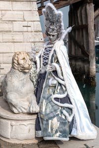 People in costume at the Venice Carnival in front of the Venetian Arsenal.