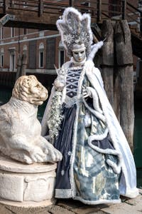 People in costume at the Venice Carnival in front of the Venetian Arsenal.