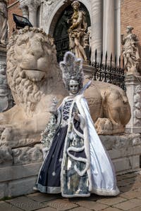 People in costume at the Venice Carnival in front of the Venetian Arsenal.