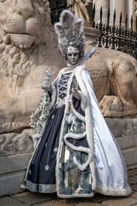 People in costume at the Venice Carnival in front of the Venetian Arsenal.