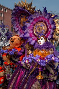 People in costume at the Venice Carnival in front of the Venetian Arsenal.