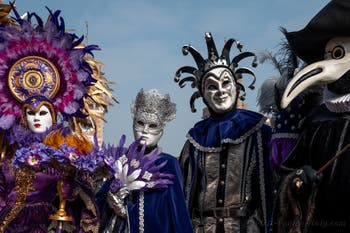 People in costume at the Venice Carnival in front of the Venetian Arsenal.