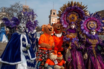 People in costume at the Venice Carnival in front of the Venetian Arsenal.