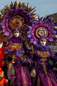 People in costume at the Venice Carnival in front of the Venetian Arsenal.