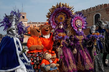 People in costume at the Venice Carnival in front of the Venetian Arsenal.