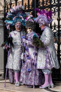 People in costume at the Venice Carnival in front of the Venetian Arsenal.