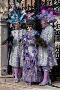 People in costume at the Venice Carnival in front of the Venetian Arsenal.