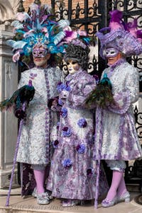 People in costume at the Venice Carnival in front of the Venetian Arsenal.