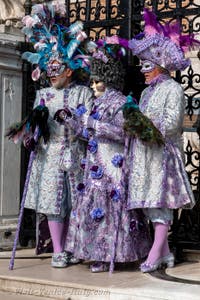 People in costume at the Venice Carnival in front of the Venetian Arsenal.