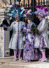 People in costume at the Venice Carnival in front of the Venetian Arsenal.