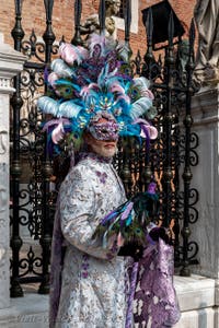 People in costume at the Venice Carnival in front of the Venetian Arsenal.