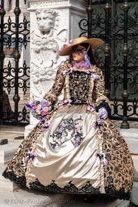 People in costume at the Venice Carnival in front of the Venetian Arsenal.