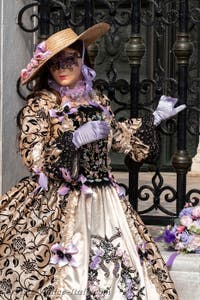 People in costume at the Venice Carnival in front of the Venetian Arsenal.