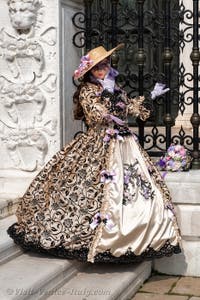 People in costume at the Venice Carnival in front of the Venetian Arsenal.